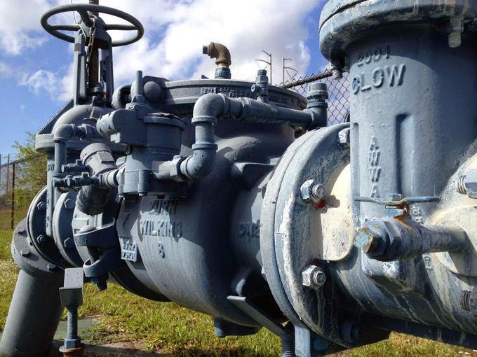 Large commercial backflow prevention assembly with gate valves on a supply main outdoors