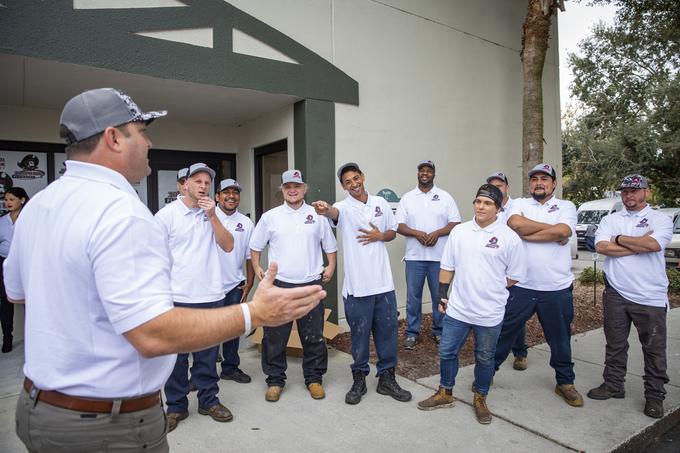 The Tampa Bay Plumbers crew gathered outside the shop for a morning briefing